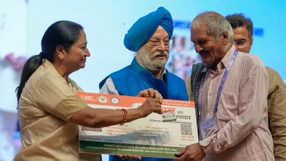 CM Rekha Gupta and Union Minister Hardeep Singh Puri distributes Ayushman Bharat cards to senior citizens at the Thyagaraj Stadium, in New Delhi.