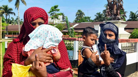 Muslim women show their ink-marked finger as she leaves after casting her vote during Panchayat elections at Baraigram in Karimganj, Friday, May 2, 2025.