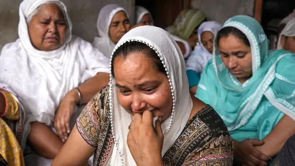 Relatives of Sukhwinder Singh, who died after consuming spurious liquor, mourn at a village in Majitha area near Amritsar district, Tuesday, May 13, 2025. At least 14 people have died in five villages in Punjab. image 