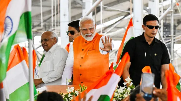 Narendra Modi with Gujarat Chief Minister Bhupendra Patel arrives at a public meeting, in Dahod, Gujarat.