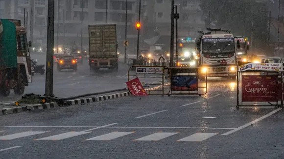 Vehicles ply on road amid heavy rainfall, in Mangaluru, Karnataka.