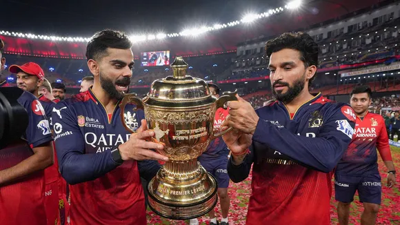 RCB captain Rajat Patidar and Virat Kohli hold the IPL 2025 championship trophy during the team's victory lap at the Narendra Modi Stadium, in Ahmedabad.