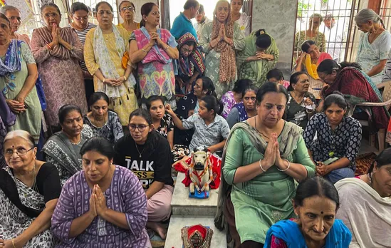 Relatives pray at the residence of former Gujarat Chief Minister Vijay Rupani in Rajkot, Thursday, June 12, 2025. Rupani was among the passengers onboard the Air India flight that crashed in Ahmedabad.