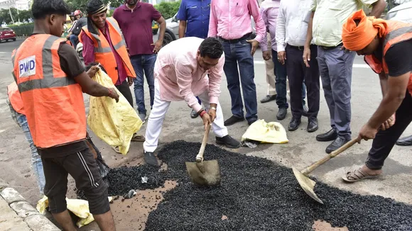 Dehi minister Kapil Mishra participates in a hands-on road repair effort on Vikas Marg, part of a PWD initiative, on Tuesday, June 24, 2025.