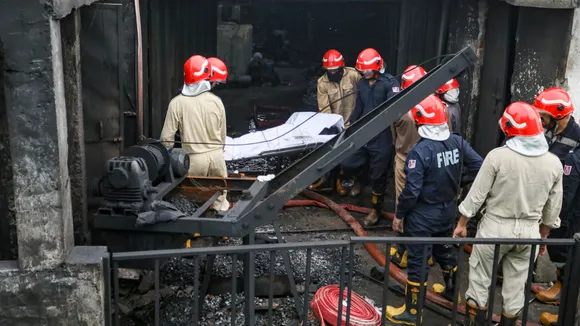 Firefighters carry a victim’s body after a fire broke out in a chemical factory at Rithala in New Delhi on Wednesday, June 25, 2025.