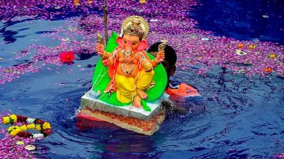 An idol of Lord Ganesh being immersed after one-and-half day during the Ganesh Chaturthi festival, at Girgaon Chowpatty in Mumbai