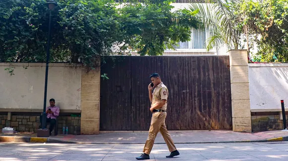 Security personnel keep vigil outside the residence of veteran actor Dharmendra, 89, who was admitted to Breach Candy Hospital, in Mumbai, Tuesday, Nov. 11, 2025.