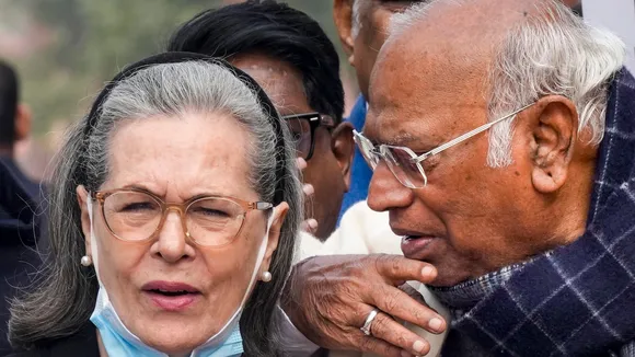 Congress President Mallikarjun Kharge, right, interacts with party leader Sonia Gandhi during Parliament's Winter session, in New Delhi, Thursday, Dec. 18, 2025.
