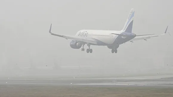 An airplane lands at Jay Prakash Narayan International Airport amid fog and low visibility, in Patna, Thursday, Dec. 18, 2025.