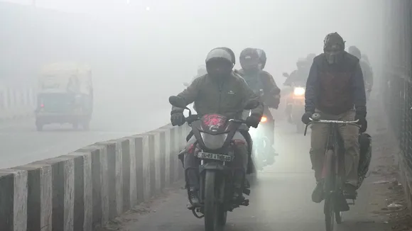 Commuters brave dense fog on a winter morning, in New Delhi, Saturday, Dec. 20, 2025.