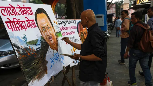 A teacher from Gurukul Art School pays tribute to Maharashtra Deputy Chief Minister Ajit Pawar by making paintings, in Mumbai, Wednesday, Jan. 28, 2026.