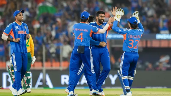 Jasprit Bumrah celebrates with teammates after taking the wicket of South Africa's Quinton de Kock at the Narendra Modi Stadium in Ahmedabad on Sunday, Feb. 22, 2026.