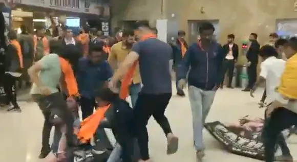 Videograb of protesters tearing posters of Shah Rukh Khan's upcoming movie Pathaan