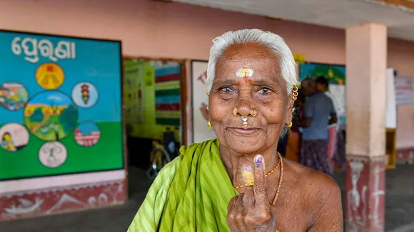 An elderly woman shows her inked finger after casting her votes at a polling booth during the fourth phase of General Elections-2024 at Gopalpur in Berhampur, Odisha, Monday, May 13, 2024