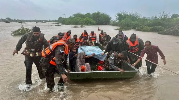 Army personnel during a rescue operation of stranded people following heavy rainfall, at flood-hit areas of Jamnagar, Rajkot and Dwarka