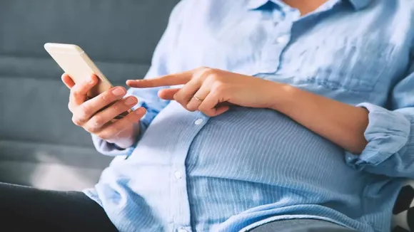 pregnant woman using phone