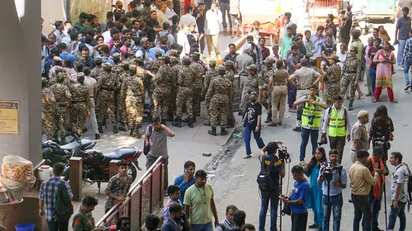 Security personnel stand guard as students protest outside Karol Bagh metro station after three IAS aspirants died in the basement of Rau's IAS Study Circle at Old Rajinder Nagar area, in New Delhi, Sunday, July 28, 2024.