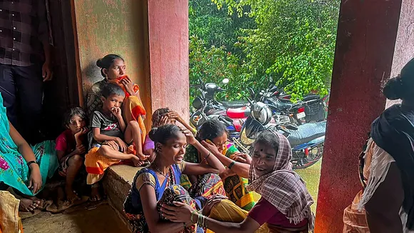 Family members of the people trapped under the rubble after a landslide at Irshalwadi village in Raigad district