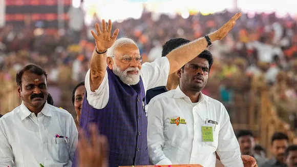 Prime Minister Narendra Modi waves at supporters as he arrives for a public meeting ahead of Lok Sabha elections, in Salem, Tamil Nadu