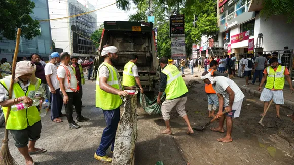 Municipal corporation workers repair a road that got damaged by rain, near a UPSC exam coaching centre, the basement of which got flooded on Saturday, resulting in the death of three civil services aspirants, in New Delhi, Sunday, July 28, 2024.