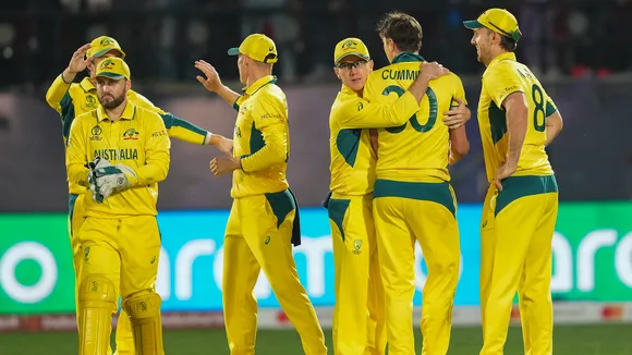 Australian pacer Pat Cummins with teamamtes celebrates the wicket of New Zealand's Rachin Ravindra during the ICC Men’s Cricket World Cup 2023 match between Australia and New Zealand, at HPCA Stadium, in Dharamshala, Saturday, Oct. 28, 2023.