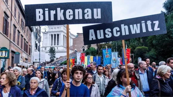 People participate in a march of remembrance marking the 80th anniversary of the roundup of the Jews of Rome in Rome, Italy, Monday Oct. 16, 2023.