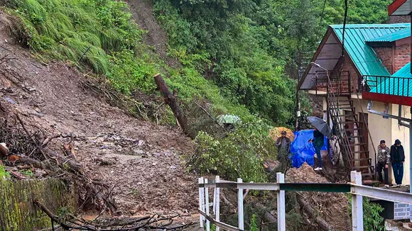 Debris on a road after landslide near a residential colony following monsoon rainfall, at Sanjauli in Shimla