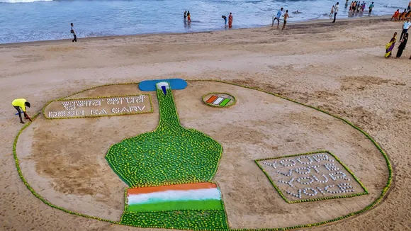 Renowned sand artist Sudarsan Pattnaik creates a sand sculpture to spread voting awareness with the message 'Chunab Ka Parba, Desh ka Garv', at Puri beach, Friday, May 24, 2024