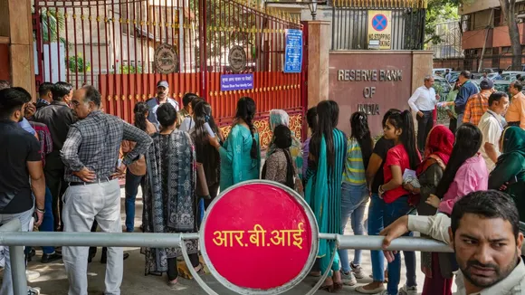 People wait to exchange their Rs 2000 notes at Reserve Bank of India office, in New Delhi