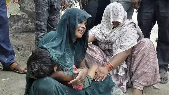 A woman is consoled as she mourns after her son died in a stampede outside a hospital in Hathras district in the northern state of Uttar Pradesh, India, July 2, 2024