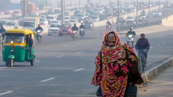 A pedestrian during a cold winter morning, in New Delhi