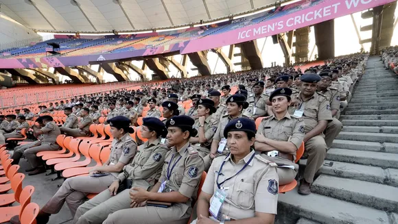 Police personnel wait for their duty orders ahead of the 2023 ICC Men's Cricket World Cup at the Narendra Modi Stadium, in Ahmedabad