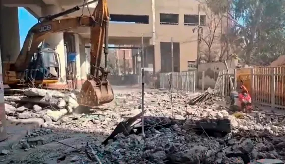 An earthmover removes debris after the collapse of a portion of Gokalpuri Metro Station, in New Delhi