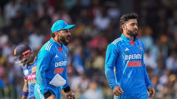 India's Riyan Parag and Virat Kohli celebrate the wicket of Sri Lanka's Charith Asalanka during the third one-day international (ODI) cricket match between India and Sri Lanka