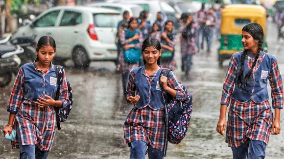 School students during rains, in New Delhi