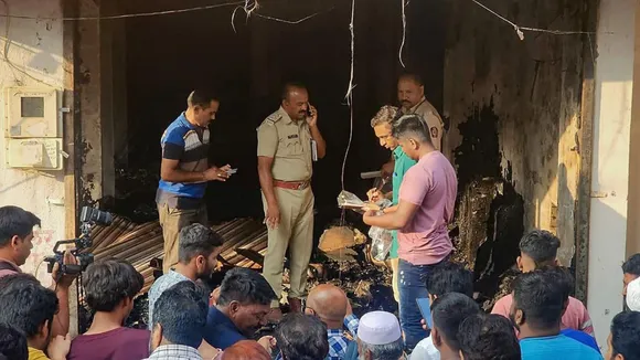 Police personnel and locals at the site after a fire broke out at a tailoring shop, in Chhatrapati Sambhajinagar, Wednesday, April 3, 2024