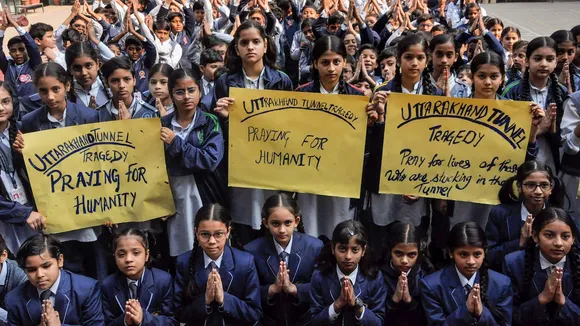 Moradabad school students pray for the workers trapped inside an under-construction tunnel in Uttarakhand Wednesday, Nov. 22, 2023.