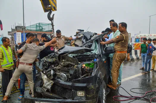 olice personnel and others near the wreckage of a car after a head-on collision with a bus on Ghaziabad-Meerut Expressway, in Ghaziabad