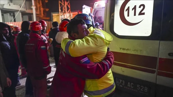 A survivor in Turkey hugs rescue worker