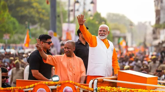 Prime Minister Narendra Modi with Uttar Pradesh Chief Minister Yogi Adityanath during a road show for Lok Sabha elections, in Varanasi, Monday, May 13, 2024
