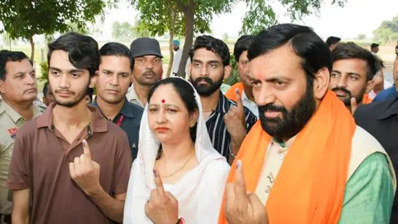 Haryana Chief Minister Nayab Saini and his family members show their fingers marked with indelible ink after casting vote at a polling station at Mirzapur during the sixth phase of Lok Sabha elections, in Ambala district, Saturday, May 25, 2024