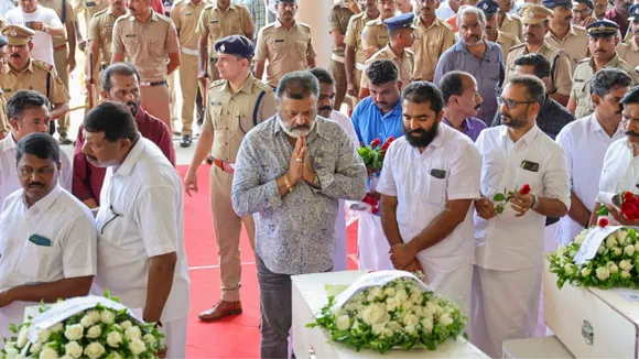 Minister of State Suresh Gopi pays respect to the mortal remains of the Indians who died in the tragic fire incident in Kuwait, after an Indian Air Force (IAF) flight carrying the remains arrived at the Cochin International Airport, in Kochi, Friday, June 14, 2024.