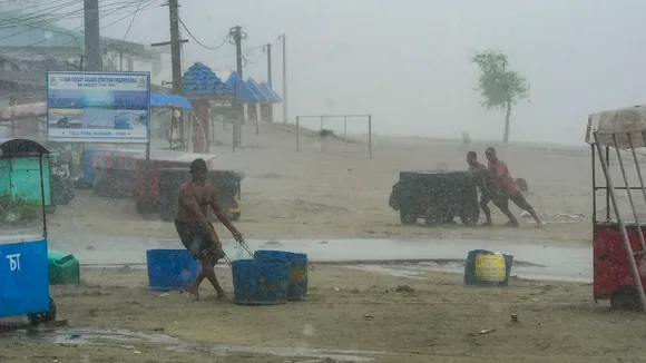 People move their belongings away from the seashore amid rain, ahead of the landfall of Cyclone 'Remal', in South 24 Parganas district, Sunday, May 26, 2024.