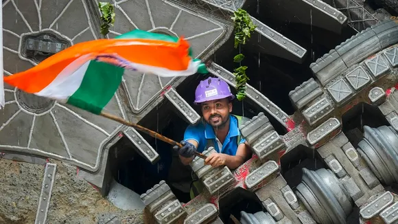 A worker celebrates after the successful breakthrough of the Tunnel Boring Machines (TBMs) 'Bhoomi' and 'Srishti' at the Pulbangash metro station site of the Delhi Metro's Phase-4 expansion, in New Delhi, Wednesday, Sept. 18, 2024.