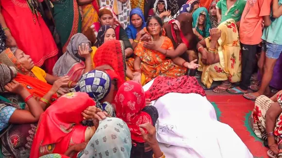 Relatives mourn near the body of a victim a day after a stampede that occured during a 'satsang' (religious congregation), in Sikandra Rao area of Hathras district, Wednesday, July 3, 2024