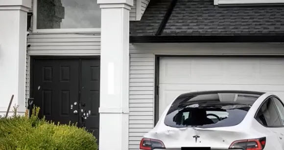 Bullet holes are pictured in a vehicle parked outside a home near the 2800 block of 154 Street in Surrey, B.C., on Thursday