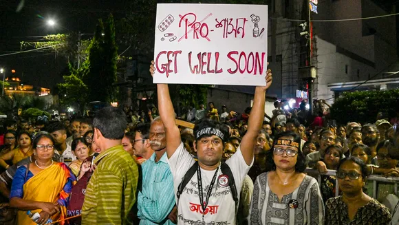 A man holds a placard during a 'mass convention' called by junior doctors near the hunger strike site, protesting against the alleged rape and murder of a trainee doctor, in Kolkata, Friday, Oct. 11, 2024.
