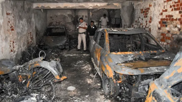 Police inspect after a fire broke out in Shakarpur, in east Delhi