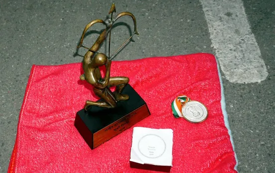 Arjuna and Khel Ratna Awards of wrestler Vinesh Phogat, left by her on a pavement near the prime minister's office as a mark of protest, in New Delhi, Saturday, Dec. 30, 2023.