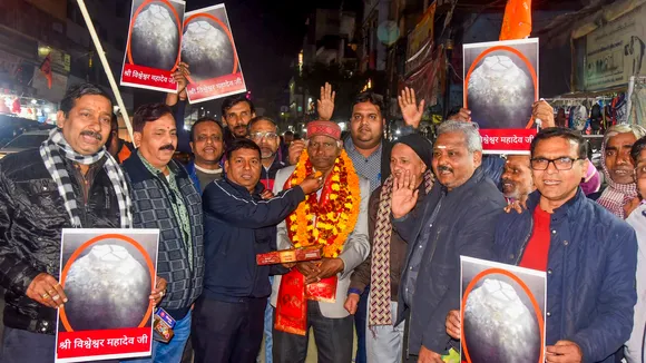 People celebrate after Varanasi district court allowed the family of a priest to worship Hindu deities in the Gyanvapi mosque cellar, in Varanasi